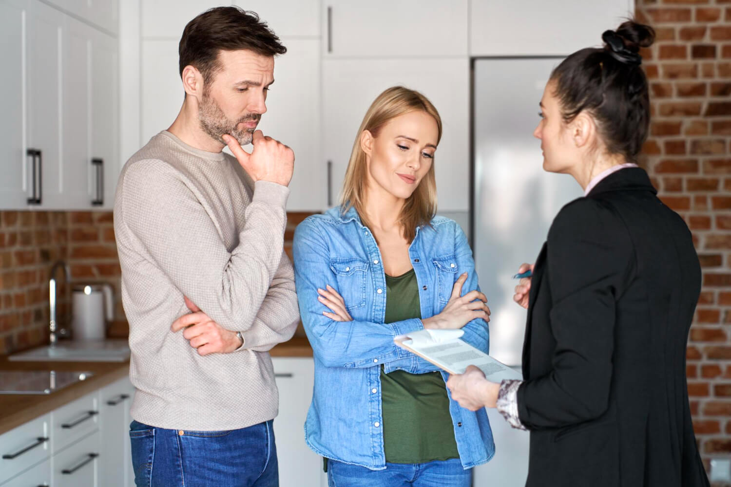 Couple consulting real estate agent about inherited property
